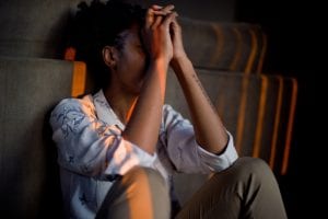 Man with hands in front of face stressed